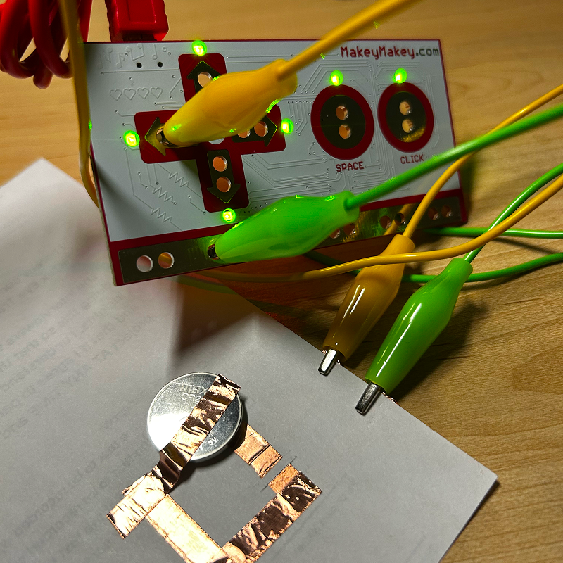 I connected the positive and negative ends with more copper tape and added a battery. Putting the battery in a random direction, I found that it made the MakeyMakey think all buttons were pressed.